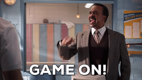 Man in a suit excitedly shouting Game On, a reaction GIF