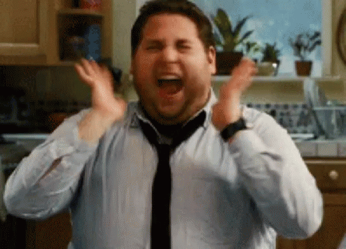 Animated meme of an excited man cheering and clapping